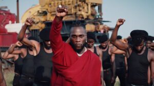 Still of Burna Boy Monsters You Made video with black men standing with fists in air