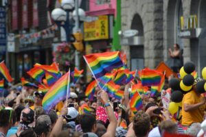 Gay pride parade with people waving gay pride flags