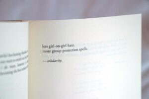Typed poetry by Amanda Lovelace on the page of a book