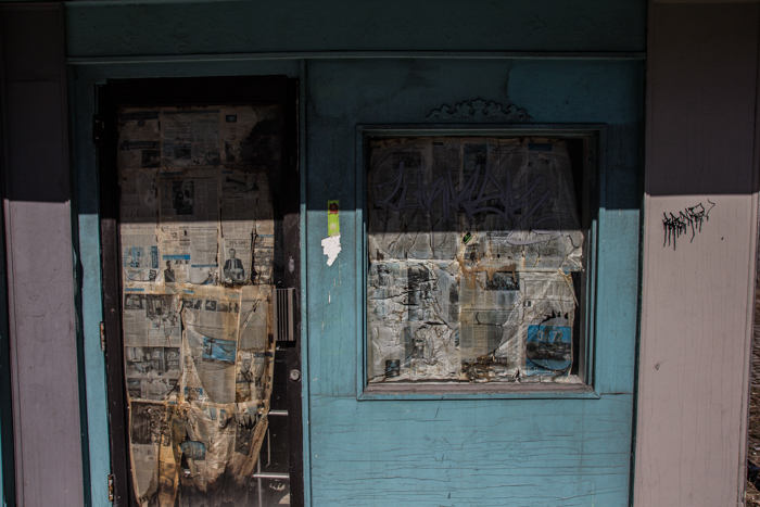 old door and window completely covered with newspaper