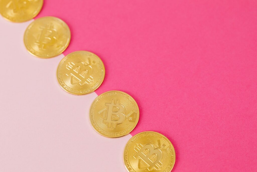 Karolina Grabowska pink halves with physical Bitcoins in the middle