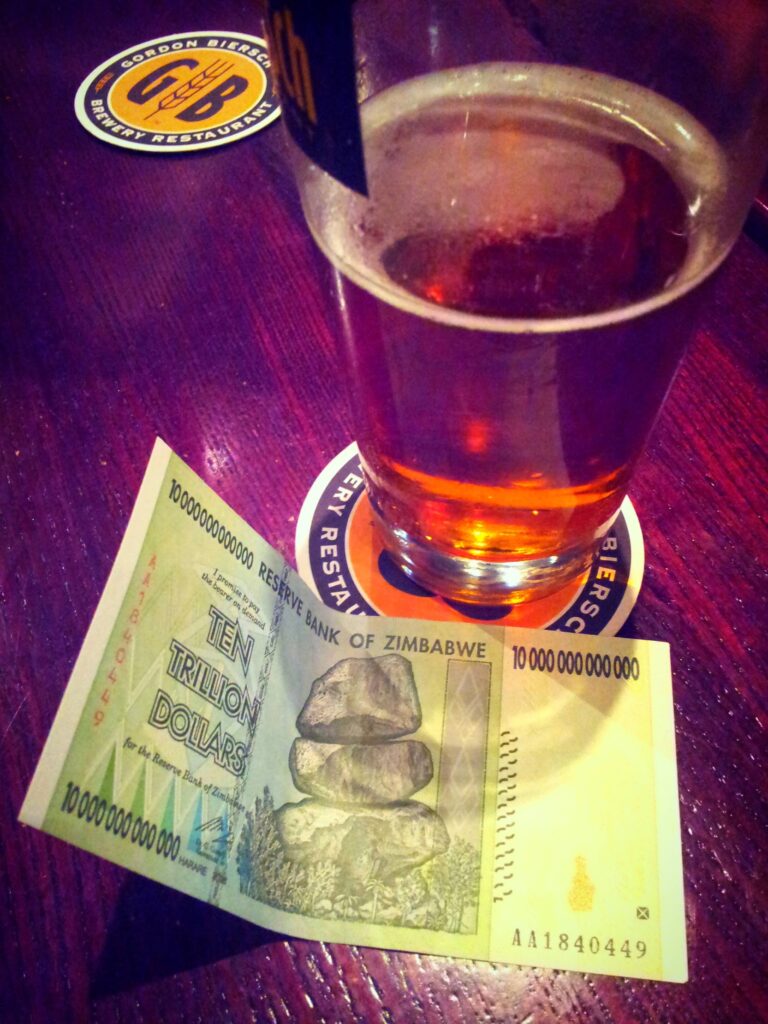 one beer and a trillion dollar bill at a bar