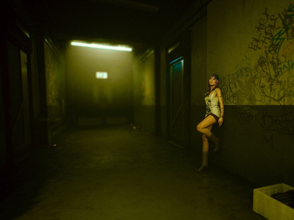 in game photography. a woman stand by a wall in the video game cyberpunk 2077. Image by Sam Horine. 